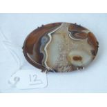 A oval gold mounted polished agate brooch