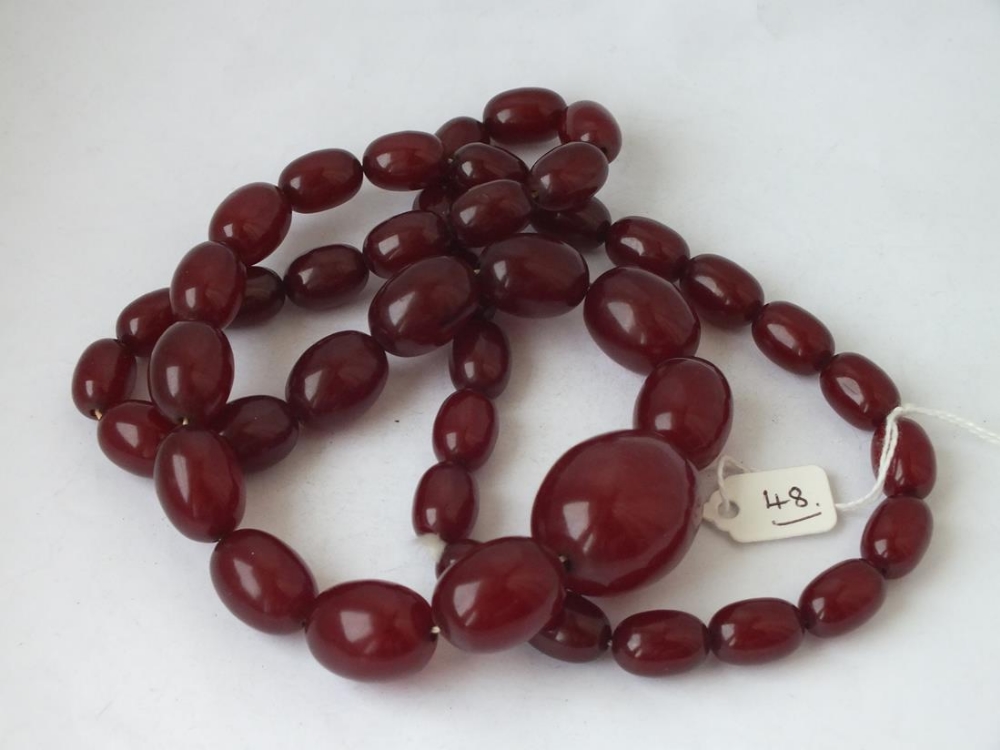 A long string of graduated cherry amber beads, 19” long, 123g