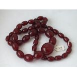 A long string of graduated cherry amber beads, 19” long, 123g