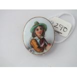 A 9ct mounted porcelain brooch painted with boy