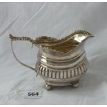 A Georgian cream jug with gilt interior, leaf capped handle – London 1816, 202g