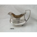 A Georgian style cream jug, gadroon rim, gilt interior 5 ½ “ over handle, 170g