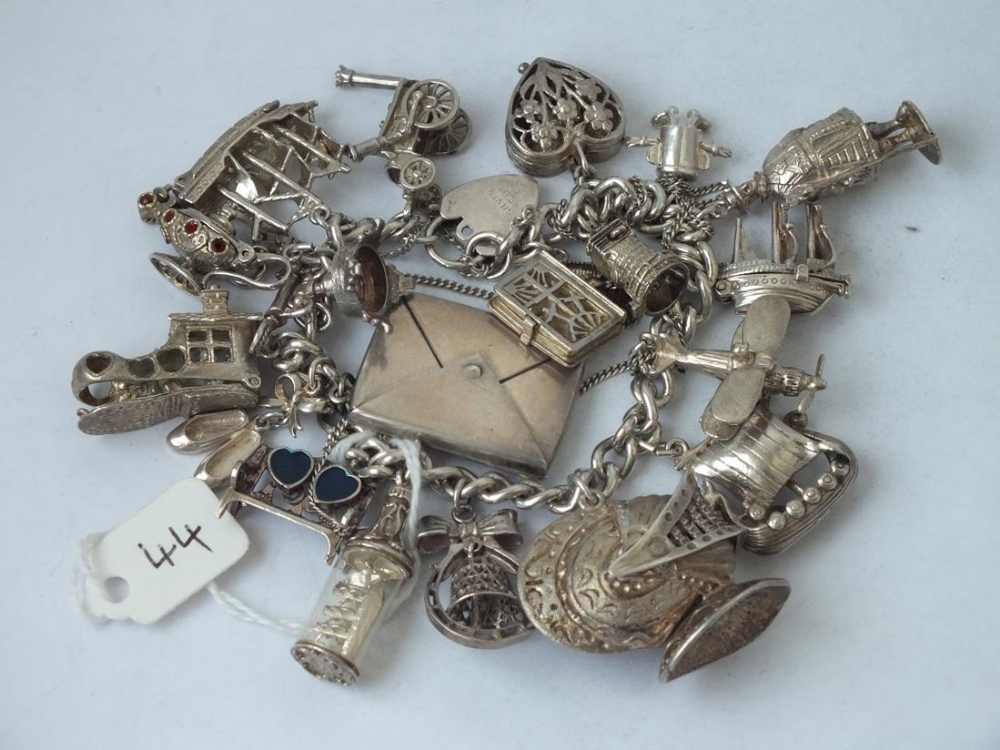 A good silver charm bracelet with stamp envelope etc., 111g