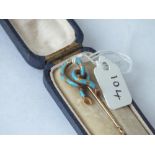A gold and blue enamel coil stick pin in fitted case, 3.7g