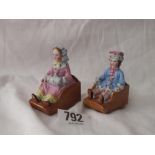 Pair of figures seated on sledges with rollers