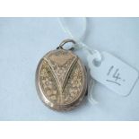 An oval Victorian gold back & front locket, hinged body engraved with flowers