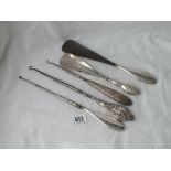 Five various button hooks and shoe horns with silver handles