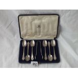 A set of six tea spoons with dog nose ends and a pair of tongs fitted box