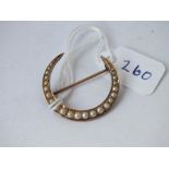 A gold and pearl antique crescent brooch