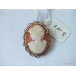 An oval carved cameo shell brooch in 9ct mount