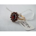 A garnet cluster ring set in 9ct, 2.7g, size P