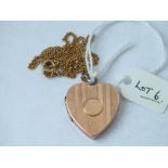 A 9ct back and front heart shaped hinged locket on a gilt neck chain