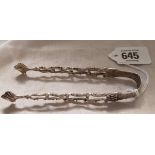 A PAIR OF GEORGIAN CAST SILVER SUGAR TONGS MARK SCRIPT J.J