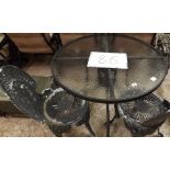 PAIR OF CAST IRON GARDEN CHAIRS AND ROUND GLASS GARDEN TABLE
