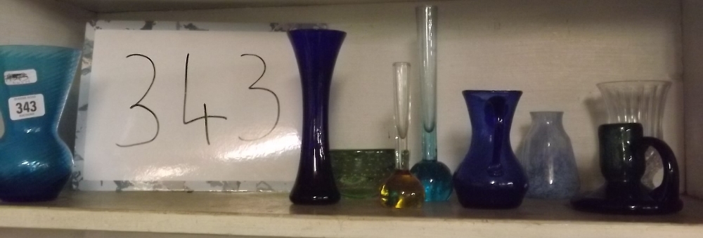 SHELF OF BLUE GLASS VASES