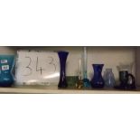 SHELF OF BLUE GLASS VASES