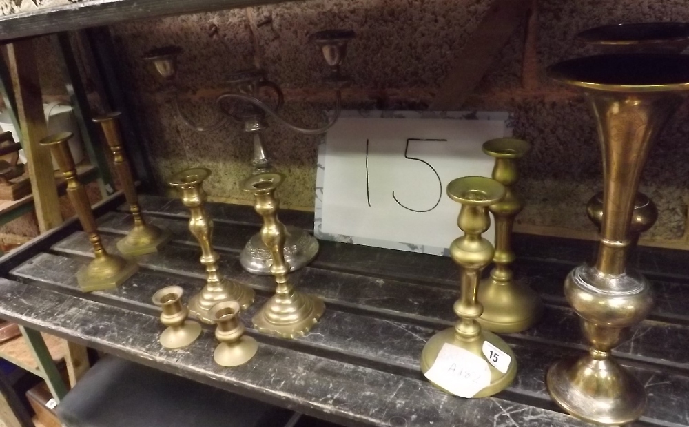 SHELF OF BRASS CANDLESTICK AND A PAIR OF ORIENTAL BRASS VASES