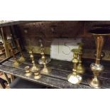 SHELF OF BRASS CANDLESTICK AND A PAIR OF ORIENTAL BRASS VASES
