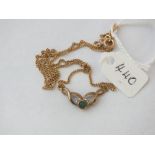 Emeral & diamond pendant set in gold in a Celtic style & suspending from a curb link gold chain -