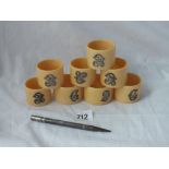 Eight napkin rings applied with initials & a propelling pencil