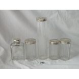 Five various silver mounted jars with engraved tops