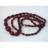Long string of graduated cherry amber beads