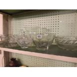 SHELF OF CUT GLASS BOWLS, CANDLESTICKS, VASES ETC