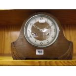 A WOOD CASED DOMES MANTLE CLOCK