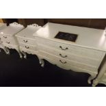 WHITE PAINTED BOW FRONTED CHEST OF THREE DRAWERS & MATCHING PAIR OF BEDSIDE CABINETS