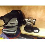 A CANON EOS 300 WITH A SIGMA ZOOM 28 - 200 MM LENSE WITH CASE