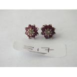 Pair of ruby & diamond cluster earrings in 9ct - 2.7gms