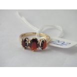 Three stone garnet ring in 9ct - size N