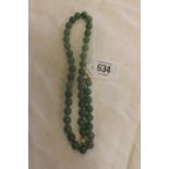 A GREEN BEAD NECKLACE