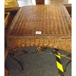 A WICKER TOPPED AND METAL COFFEE TABLE OR STOOL