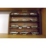 A DISPLAY SHELF OF JAGUAR CLASSIC MOTOR CARS IN PEWTER BY THE DANBURY MINT