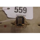 A SMOKY QUARTZ RING SET IN 9CT