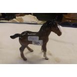 A BESWICK FIGURE OF A YOUNG BROWN PONY