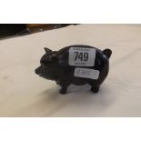 A BLACK FAT PIG MONEY BOX POSSIBLY BESWICK OR SILVAC