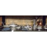 SHELF OF PLATED WARE INCL: TUREEN'S, NAPKIN RINGS, COASTER & A COPPER KETTLE