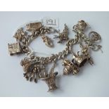 A silver charm bracelet - 64gms
