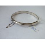 A hallmarked silver rope twist edged bangle