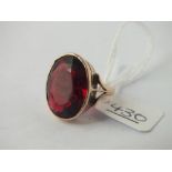 A large oval red stone dress ring set in 9ct - size H - 6.6gms