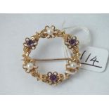 A large circular amethyst & pearl brooch in 9ct- 4.3gms