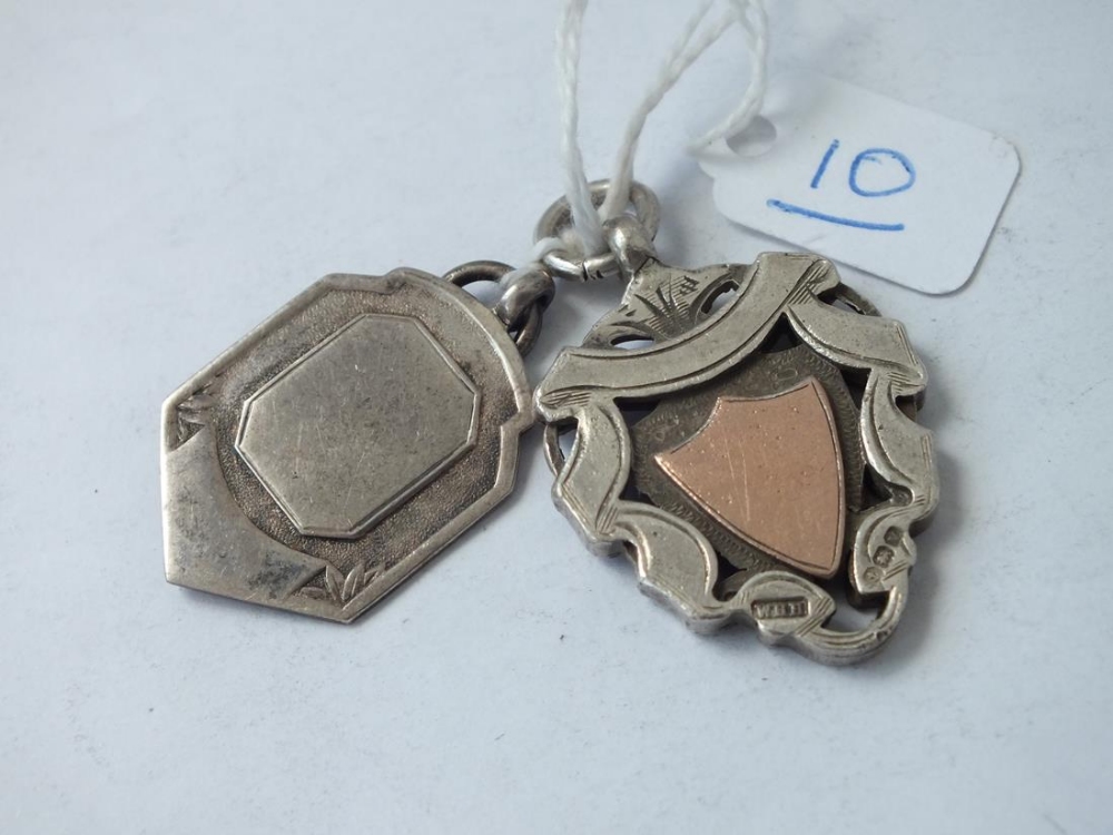 Two silver fobs - one with gold overlay decoration