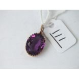 A oval purple stone pendant in 9ct