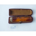 A cased silver mounted amber cigarette holder