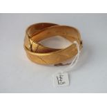 A pair of rolled gold bangles