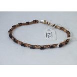 A 9ct sapphire stone set line bracelet in 9ct - 7.5gms