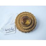 A citrine circular target brooch set in 15ct gold - 9.7gms