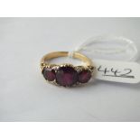 A 3 stone garnet ring with diamond corners in 18ct gold - size M - 4.4gms